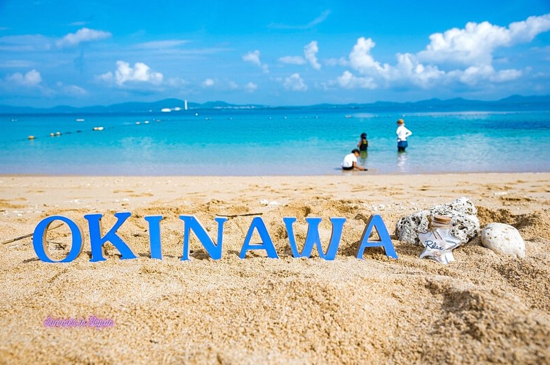 a blue letters on a beach